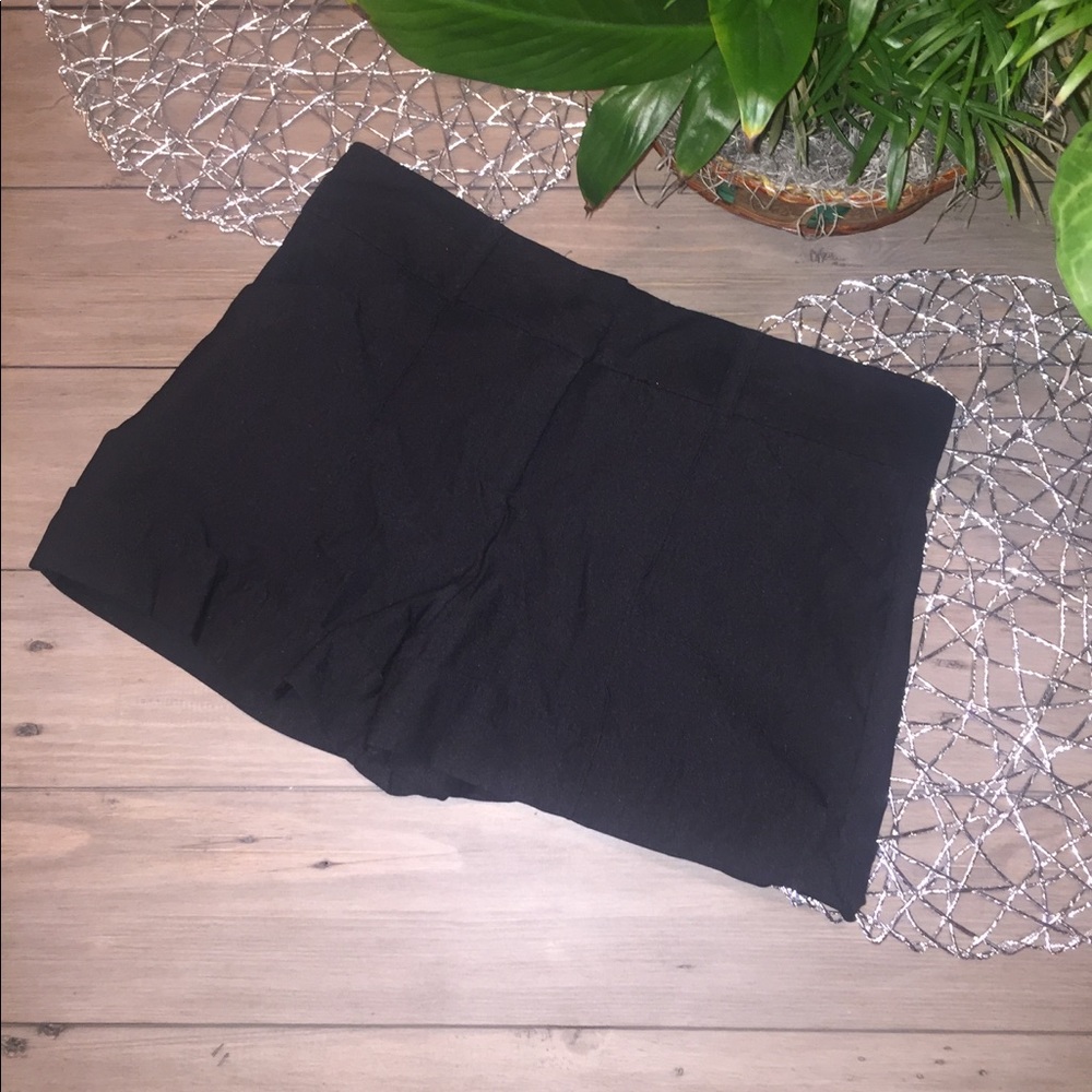 Super stretchy black hemmed shorts.